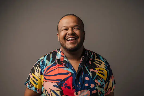 Smiling man wearing colorful outfit in studio