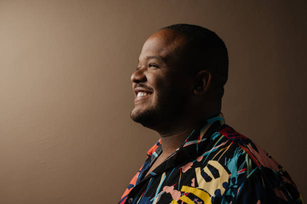 Profile portrait of smiling black man in studio stock photo