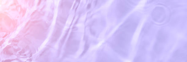 istock Serum or water texture close up. Light purple and pink gradient liquid gel background. Transparent beauty skincare sample. Cosmetic clear liquid cream smudge. Long banner with copy space 1389361590