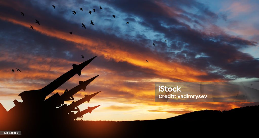 The missiles are aimed at the sky at sunset. Nuclear bomb, chemical weapons, missile defense. The missiles are aimed at the sky at sunset. Nuclear bomb, chemical weapons, missile defense, a system of salvo fire. Missile Stock Photo