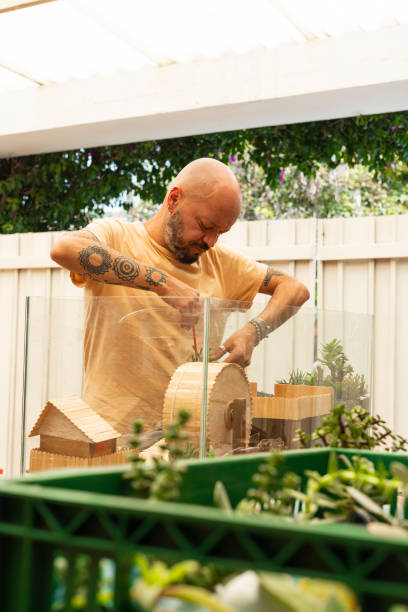istock Artist makes a work with succulent plants while depositing them in a fish tank as a home for a hamster 1389362905