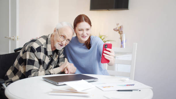 istock Woman and old man communicate with relatives via video call 1389363728
