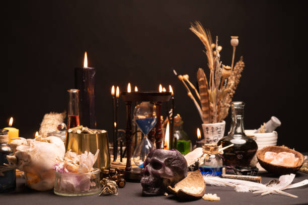 istock Selective focus on human skull candle. Occult and esoteric witch doctor still life. Halloween with magic objects. Black candle, crystal stones, teeth potions bottles on witch table. Mystic witchery. 1389363868