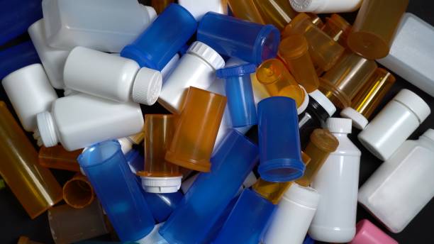 istock Medical waste. Empty pills bottles or packs for medications. Disposing empty medication containers made of plastic. Hospital waste. Pharmaceutical industry. Overbooked hospitals treatments. 1389364020