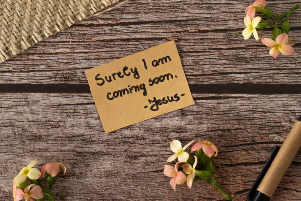 I am coming soon, Jesus Christ's words, a handwritten text quote on wood background with flowers in vintage style stock photo
