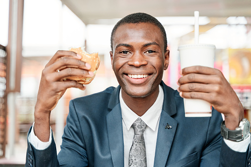 man showing hamburger and soft drink