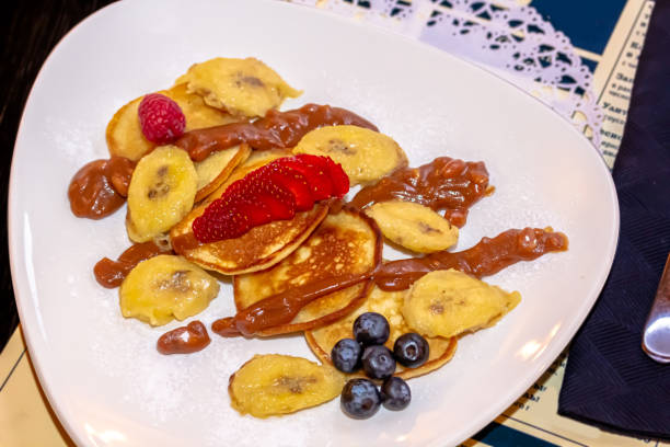 istock Pancakes with bananas, strawberries and blueberries are on a plate 1389366385