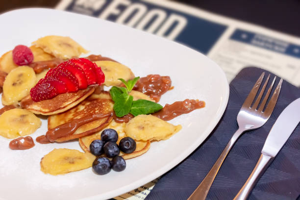 istock Pancakes with bananas, strawberries and blueberries are on a plate 1389366389