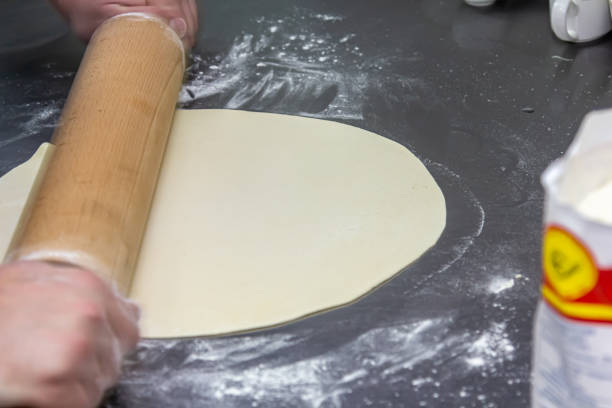 istock The cook rolls the dough into a thin sheet. 1389366422