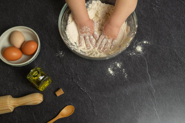 istock hands kneading ingredients to make homemade cake. 1389367727