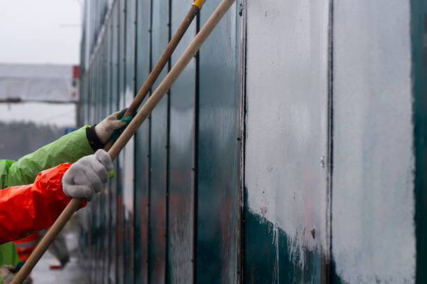 istock The painter paints with white paint. Paints graffiti with paint. 1389369857