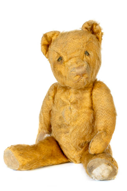 istock Old Shabby Teddy Bear Sitting Isolated on White 1389370904