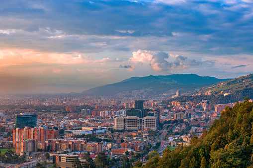 Bogota Colombia - It is sunset time in the Northern part of the Capital city and District of Usaquén in Bogotá, Colombia, South America as viewed from the heights of La Calera on the Andes Mountains. The city at street level is located at an altitude of 8,660 feet above mean sea level. Downtown Usaquén with its modern office buildings can be clearly seen. Horizontal format; copy space.