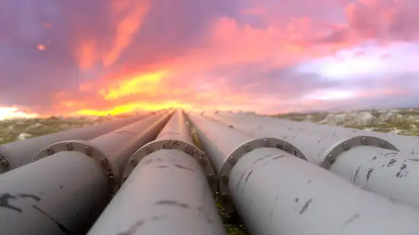 Photo of Industrial pipelines and valves on sunset sky background, banner.