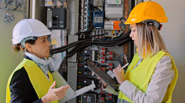 istock Female engineers working in solar power plant. Teamwork. Renewable energy systems. Solar city. 1389380772
