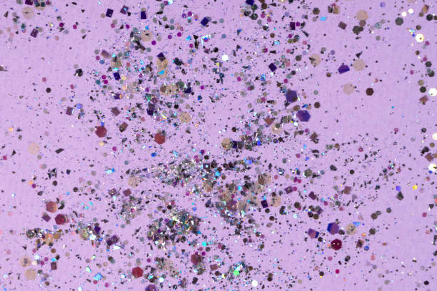 istock Silver holographic sequins on a pastel purple background 1389381592