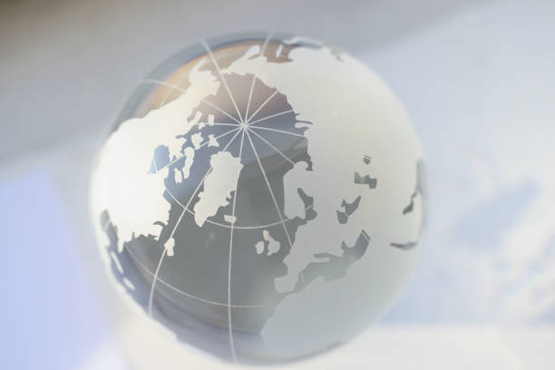 Close-up of grey glass world globe, round shaped earth miniature with continents. Environment, ecology problem, population, infection spread, map concept