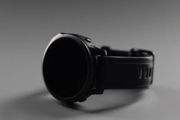 istock Trendy minimalistic device, black male wristwatch lying on grey background 1389381954