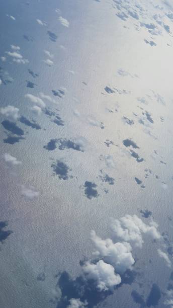 istock Clouds above the calm sea from bird's eye view 1389384155