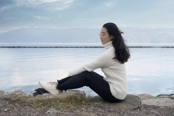 istock A girl blowing on the beach 1389388269