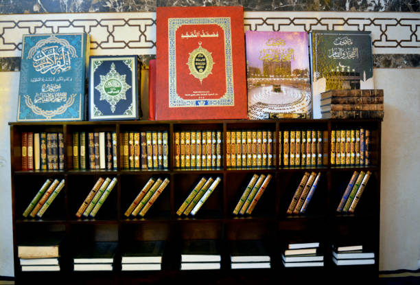manuels du coran à l’intérieur d’une étagère en bois de différentes tailles, traduction de texte arabe (le noble coran, tahajjud night prayers quran) - bibliothèque islam photos et images de collection