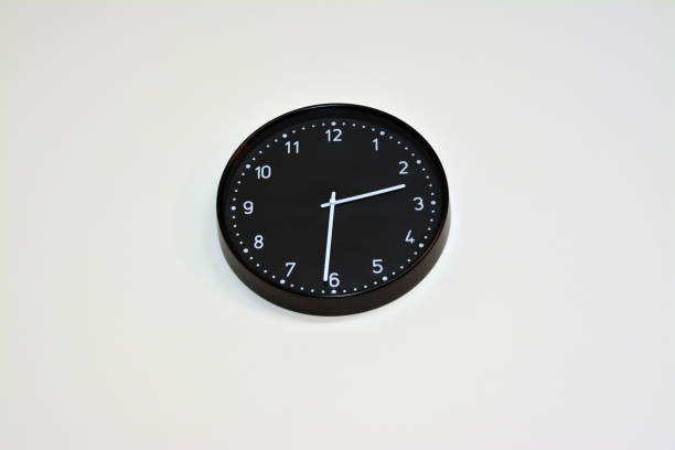 istock A black big clock hanging at the wall, time concept background 1389391764