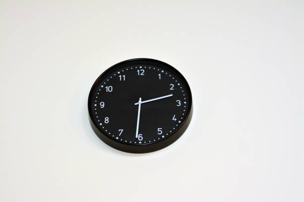 istock A black big clock hanging at the wall, time concept background 1389391850