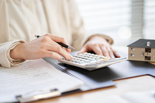 Close-up Businessman using calculator while working with financial reports and phone at office