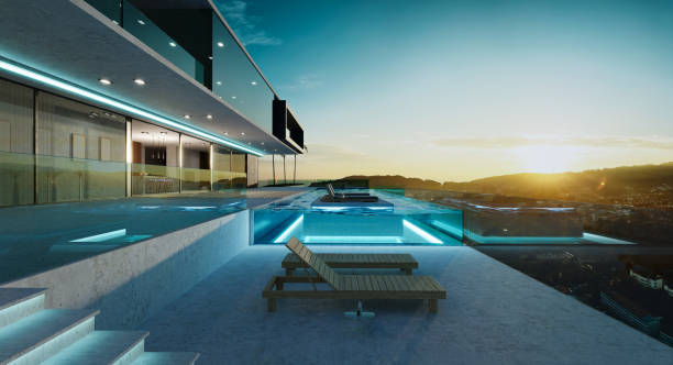Luxury villa exterior design with beautiful sunset at the infinity pool stock photo