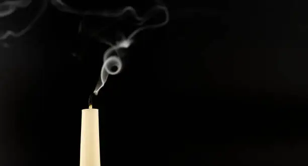 Photo of Blown out candle over a black background