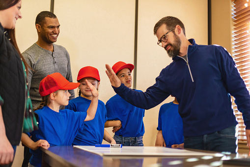 Youth Baseball Team Multicultural Male and Female Children with Parents and Insurance Agent Planning and Preparing for a Fundraising Event (Shot with Canon 5DS 50.6mp photos professionally retouched - Lightroom / Photoshop - original size 5792 x 8688 downsampled as needed for clarity and select focus used for dramatic effect)