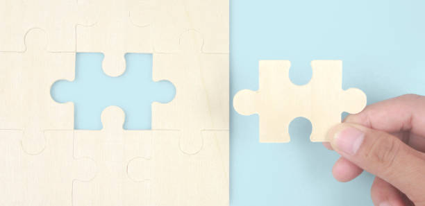 istock Connecting jigsaw puzzle in hand. Business solutions success and strategy concept 1389417100