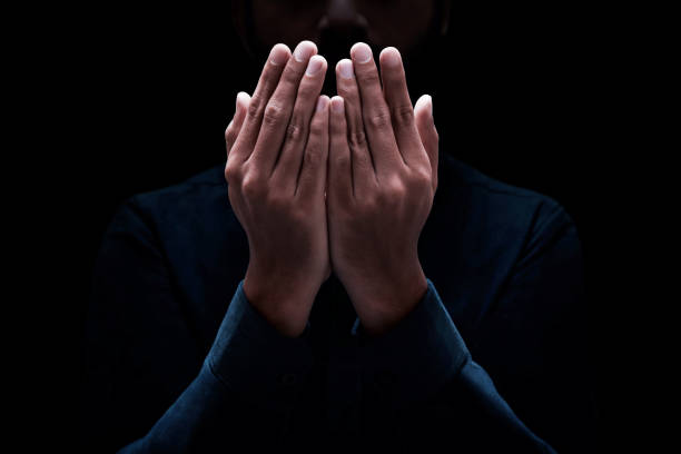istock Muslim man praying on dark background 1389421057