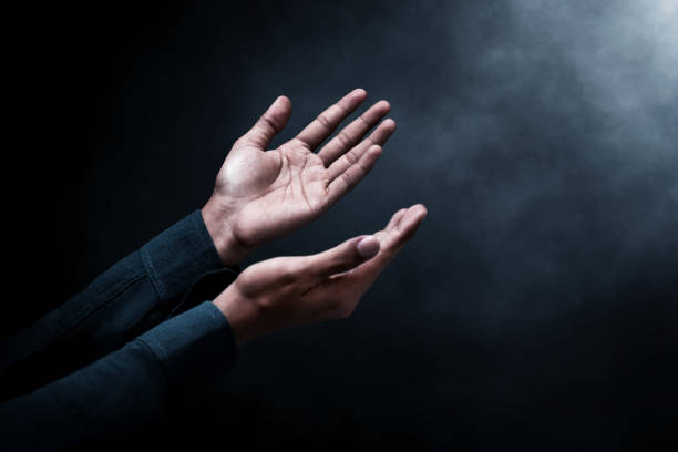 istock Muslim man praying on dark background 1389421058