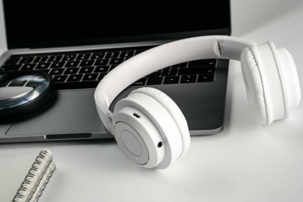 istock Computer, magnifying glass, glasses, headphones and mobile phone on white background board 1389421393