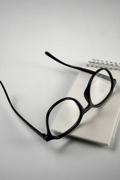 istock Glasses and notebooks on a white background 1389421398