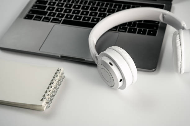 istock Computer, magnifying glass, glasses, headphones and mobile phone on white background board 1389421409