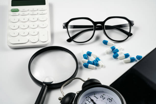 istock Alarm clock, computer, magnifying glass, calculator and medicine on white background board 1389422261