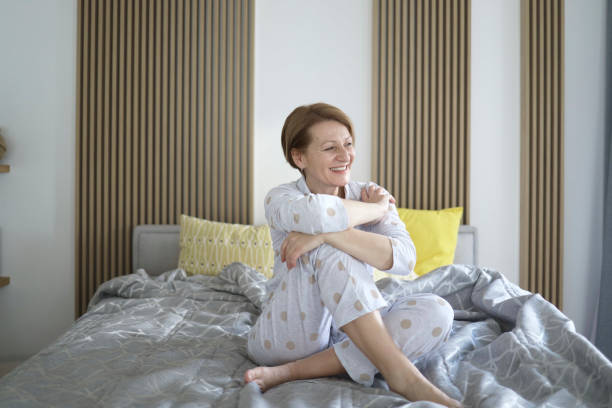 istock Senior woman waking up routine relaxing on the bed 1389426236