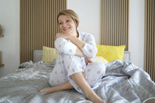istock Senior woman waking up routine relaxing on the bed 1389426240