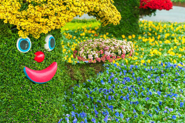 istock A cheerful cartoon tree in flower garden 1389430406