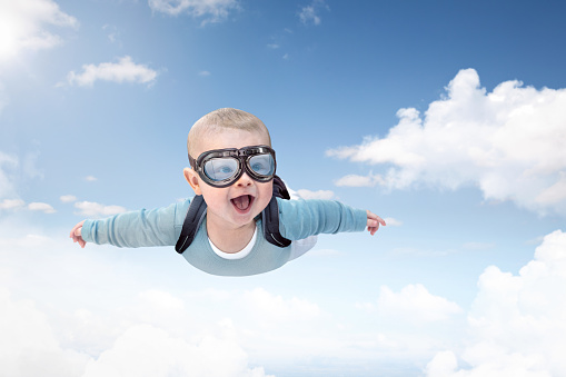 Funny composite of a skydiving baby flying through the sky.