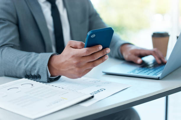 istock Closeup shot of an unrecognisable businessman using a cellphone while working in an office 1389432732