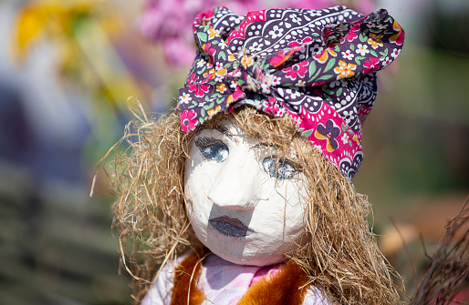 Sewing crafts. Traditional ethnic handmade cloth doll. Doll with straw hair.