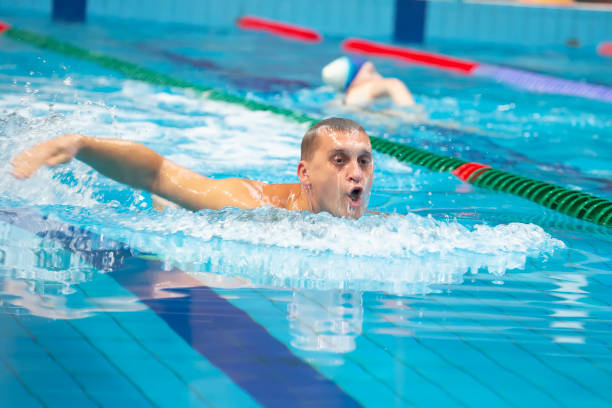 istock Male swimmer swims in the pool. 1389432795