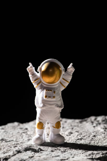 istock Spaceman on surface of rocks.  Astronaut in deep black space. 1389433727