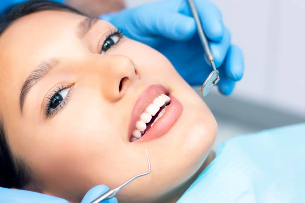 istock dentist examines the patients teeth at the dentist. close up 1389435341