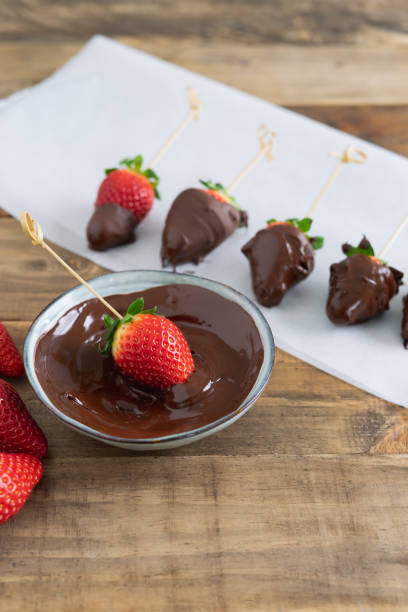 istock Strawberries with chocolate. Strawberry perched in the chocolate bowl. Copy space. 1389436106