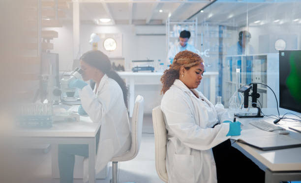 istock Shot of a young woman making notes while working in a lab 1389436569
