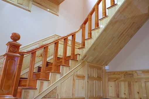 Beautiful wooden stairs. Golden stair made of wood, safety protection wooden stairs architecture interior design of contemporary, Modern house building stairway.
